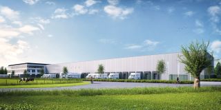 beeld van het gebouw van Dekeyzer-Ossaer, met bestelwagens voor de deur, mooie blauwe lucht en groen gras op de voorgrond